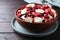 Bowl of different freeze dried fruits on wooden table, closeup