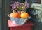 Bowl with dried flowers and orange pumpkins in autumn