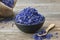 Bowl of dry blue cornflowers, sack of coneflower petals.