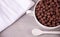 A bowl of dry chocolate balls cereal on the gray table for health breakfast