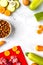 Bowl of dry dogfood, carrot, courgette, meat table background top view mock-up