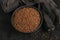 Bowl of dry raw buckwheat groats on a dark background. Cooking buckwheat porridge concept