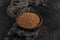 Bowl of dry raw buckwheat groats on a dark background. Cooking buckwheat porridge concept.