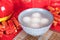 A bowl of dumplings or Lantern Festival on a festive background. The Chinese characters in the picture mean `happiness` and `good