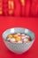 A bowl of dumplings for the Lantern Festival on a red background