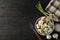 Bowl with dumplings, towel, fork and spices on background, top view