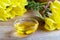 A bowl of evening primrose oil with fresh blooming evening primrose