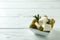 Bowl with feta, olives and rosemary on white wooden background