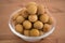 Bowl filled with an heap Dimocarpus Longan fruit on wooden background