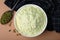 Bowl of flour, spoon and mung beans on beige background, flat lay