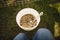 Bowl of food for chicken placed on the ground next to a lush green grassy area