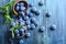 Bowl of fresh blueberries on blue rustic wooden table from above