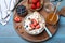 Bowl of fresh cottage cheese, berries with almond and ingredients on turquoise wooden table, flat lay