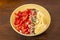 Bowl of fresh fruits. banana slices, strawberry chunks, pomegranate grains, pumpkin seeds