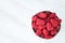 Bowl of fresh red raspberries for dessert, round white ceramic bowl, white marble background