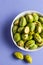 Bowl of freshly roasted pistachio nuts on table