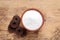 Bowl of fructose powder and fruit leather rolls on wooden table, flat lay