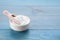 Bowl of fructose powder on light blue wooden table. Space for text