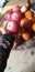 Bowl of fruit, holding large apple