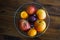 Bowl with fruits, on dark wooden table