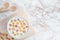 Bowl of fruity cereal on a marble background top view flat lay