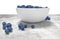 Bowl full of blueberries on conrete table.