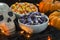 A bowl full of candy corn in a Halloween theme