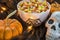 A bowl full of Halloween candy corn in a spooky setting