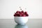 Bowl full of red ripe cherries with copy space
