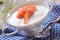 Bowl of gourmet chowder with raw salmon