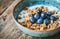 a bowl of granola, blueberries and milk