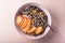 Bowl of granola with yogurt, peach slices and bluberry