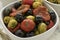 Bowl with green and black olives, peppers and tomatoes