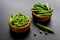 Bowl of green pea pod with beans on kitchen desk. Close up