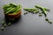 Bowl of green pea pod with beans on kitchen desk. Close up