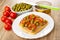 Bowl with green peas, knife on jar with meat pate, tomates cherry, sandwich with meat pate and tomato in plate on wooden table