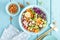 Bowl with grilled chicken meat, brown rice and fresh vegetable salad of avocado, radish, cabbage kale, carrot, and lettuce leaves