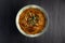 A Bowl of Haleem on a Black Background