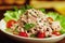 Bowl with healthy appetizing tuna salad with small tomatoes and lettuce leaves