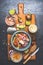 Bowl with Healthy canned Tuna fish salad ingredients : avocado, tomatoes and lime on rustic cutting board and dark background