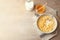 Bowl with healthy cornflakes, milk and honey on light table