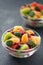 Bowl of healthy fresh fruit salad on black background