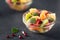 Bowl of healthy fresh fruit salad on black background