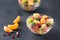 Bowl of healthy fresh fruit salad on black background