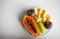 Bowl of healthy fresh fruit salad on white background. Top view. Mangosteen, papaya, carambola, jackfruit.