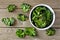 Bowl of healthy kale chips, top view on wood