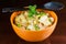 Bowl of healthy pasta with spring vegetables and bacon