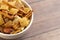 Bowl of Homemade Cereal Nut and Prezel Trail Mix on a Wooden Table