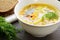 Bowl of homemade fish soup served with dark bread and dill