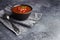 Bowl of homemade gazpacho soup. Copy space, grey stone background.